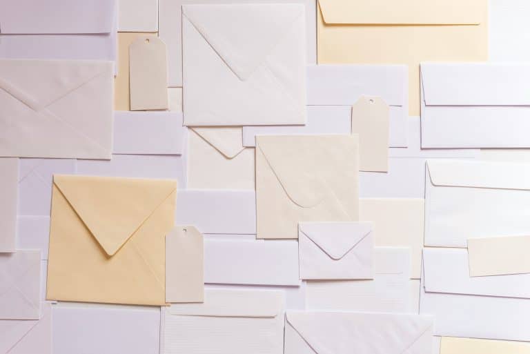 Subject Access Request - envelopes are spread across a table in a variety of shapes and sizes, in various shades of yellow, cream and white.