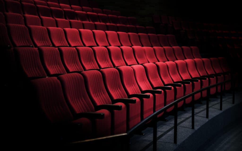 Rows of red seats in a theater intended to indicate people attending venues that might be impacted by Martyn's Law and may be interested in the data protection elements involved.