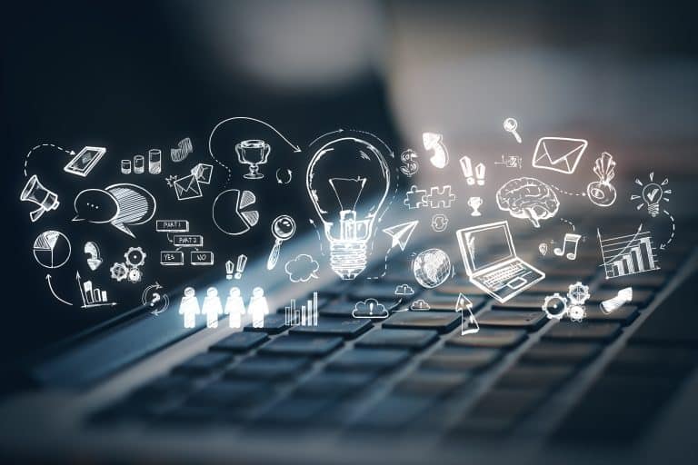 The DUAA will change marketing for charities. The image, to represent this, shows a keyboard with an overlay of sketches in white of icons, such as a lightbulb, a keyboard, a note pad, people holding hands and various small icons,